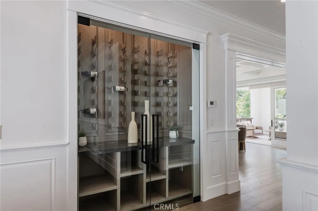 Custom built wine cabinet is located at the west hall from the dining room prior to entering the living room & kitchen