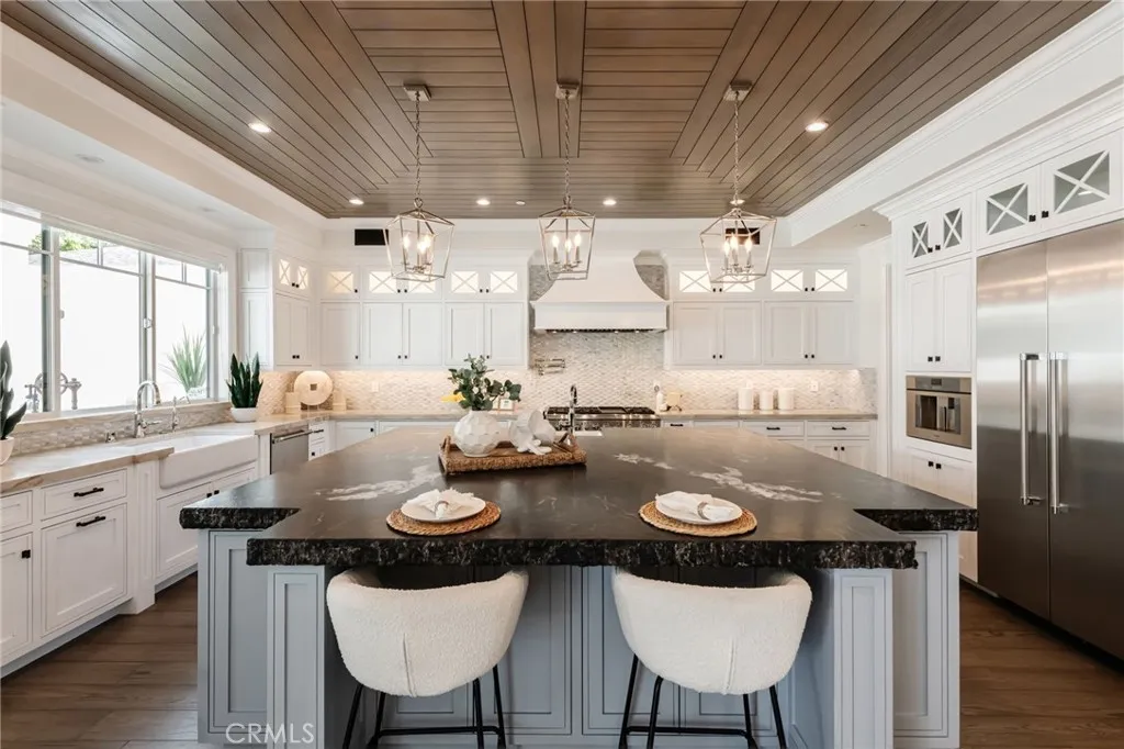 Abundance of windows showcase the beautiful backyard with pool, spa, fire pit and built in bbq area