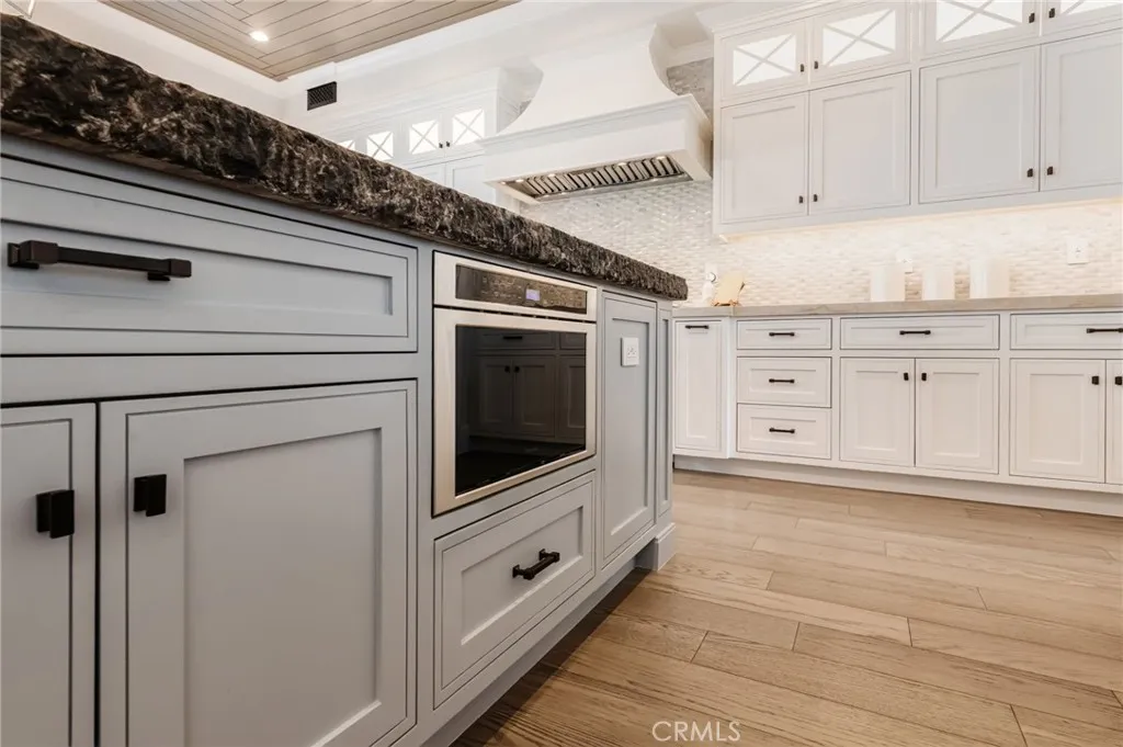 Center island is equipped with an abundance of built in storage and cabinetry