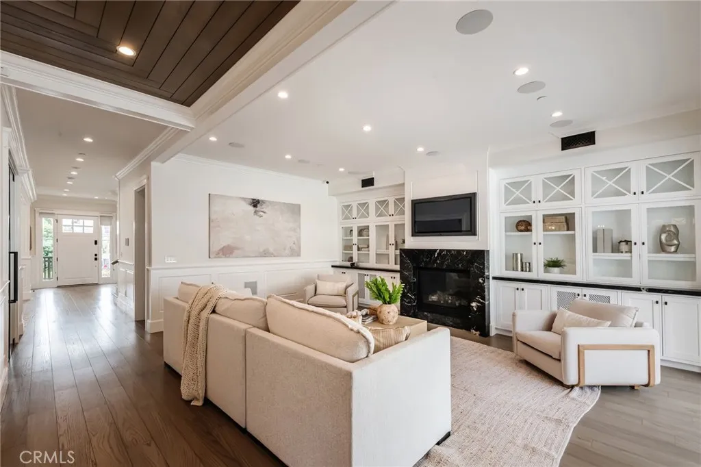 View from the living room to the hall, stairs, elevator, dining room, office, front door