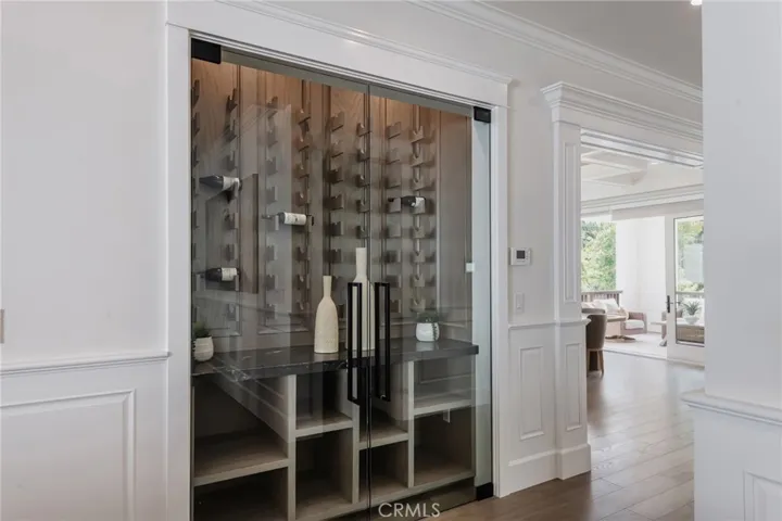 Custom built wine cabinet is located at the west hall from the dining room prior to entering the living room & kitchen
