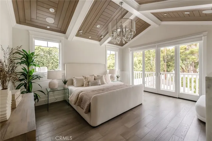 Primary suite is light and bright.  Balcony overlooks the pool.