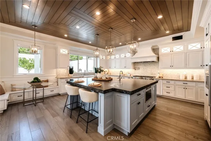 Huge island, abundance of cabinetry, beautiful stonework & wood ceilings