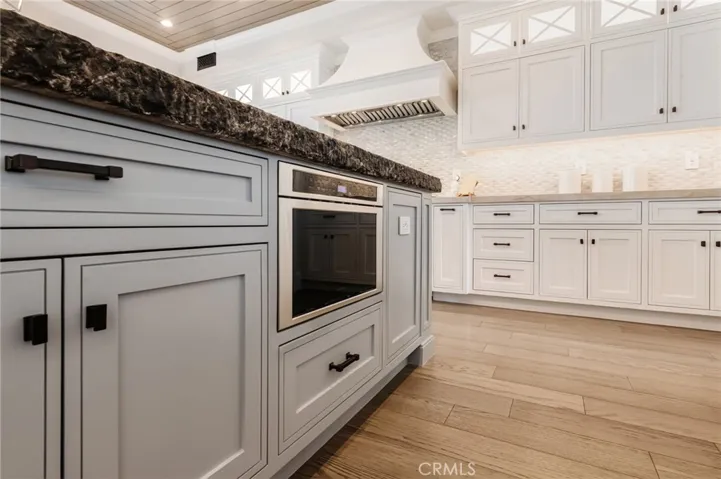 Center island is equipped with an abundance of built in storage and cabinetry