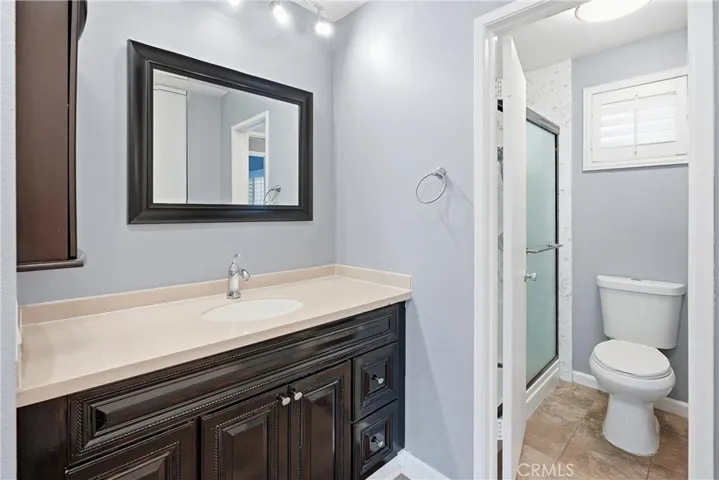 Separate vanity for primary bedroom. Toilet and shower shared with bedroom 2