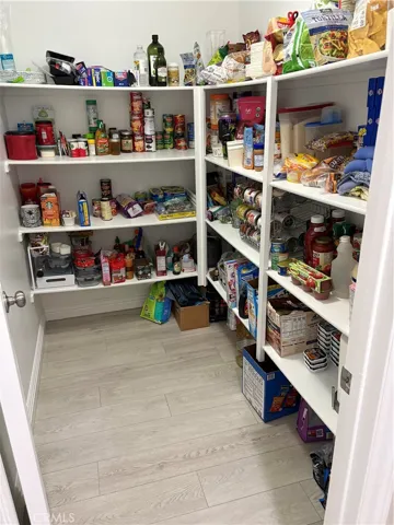 Walk-in Pantry just off the Kitchen with lots of shelves.