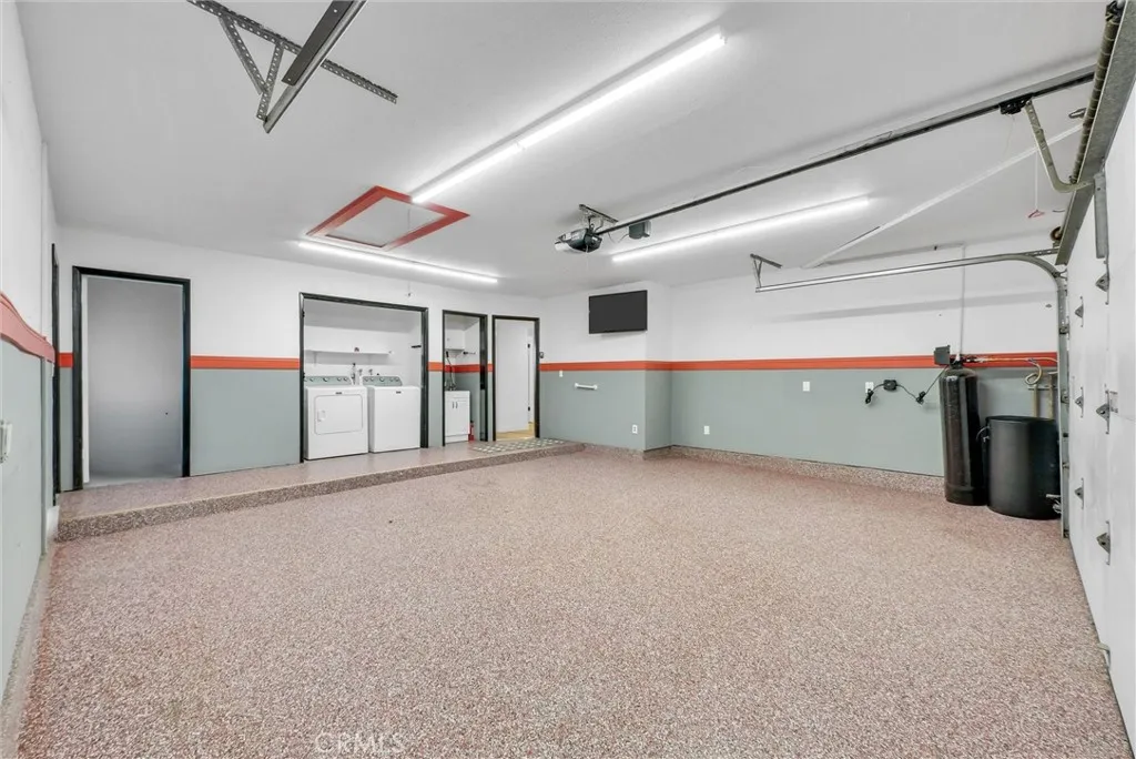 Garage is spacious and finished with epoxy flooring, laundry, utility sink and giant walk-in storage closet. There is also a water softener and EV charging outlet.