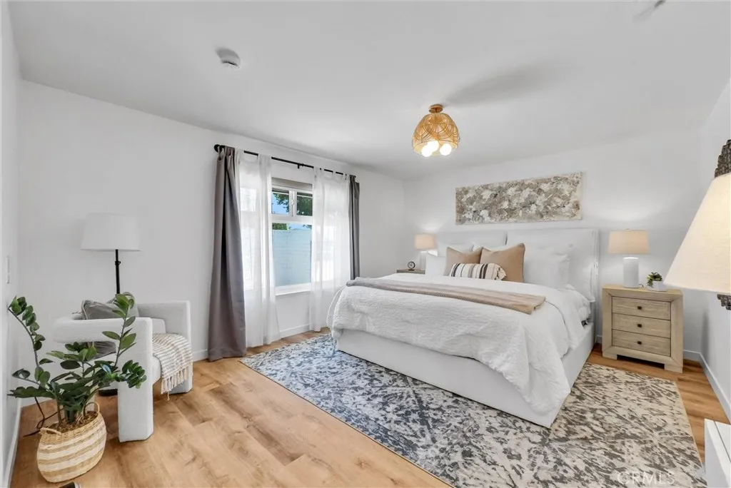 The primary suite overlooks a private courtyard and features modern updated fixtures.