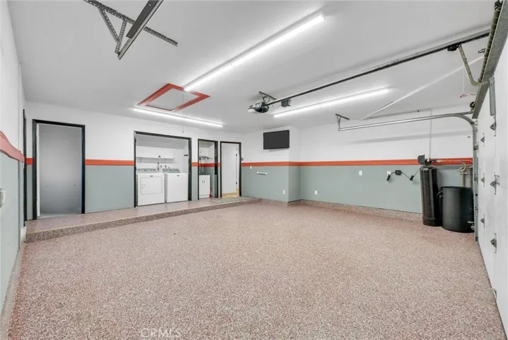 Garage is spacious and finished with epoxy flooring, laundry, utility sink and giant walk-in storage closet. There is also a water softener and EV charging outlet.