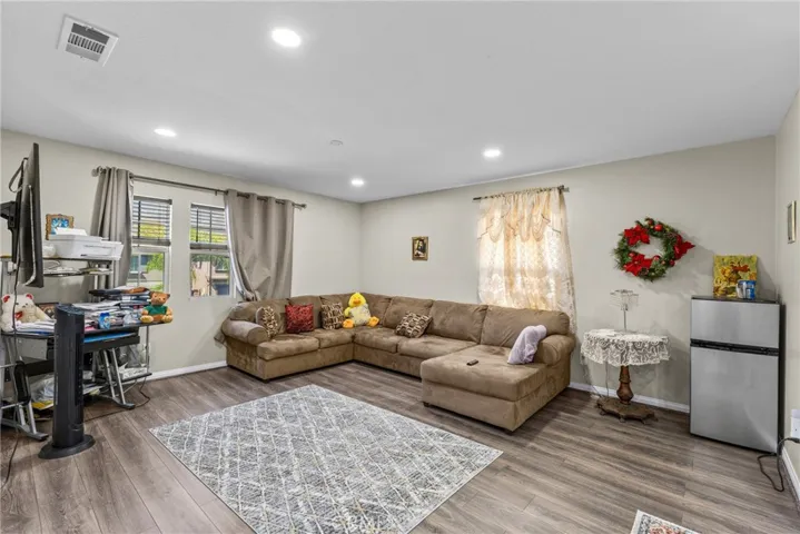 Cozy living room area with sleek flooring and natural light.