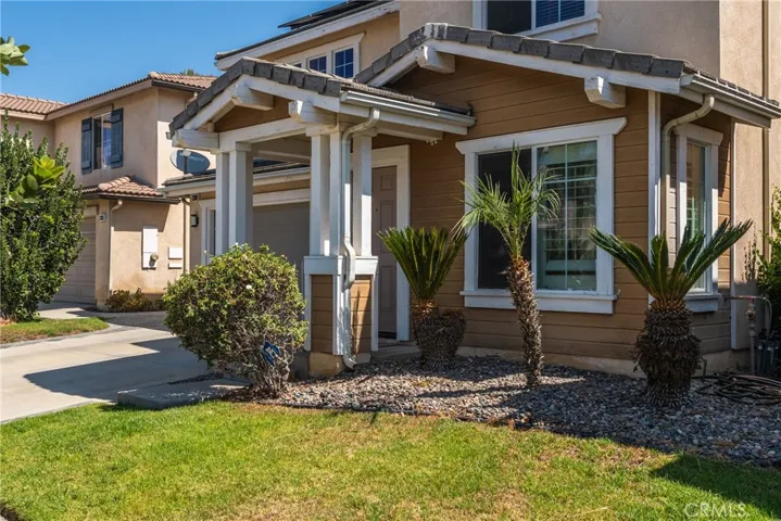 Inviting front entrance with beautiful landscaping.