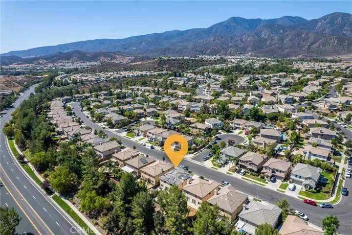 Expansive aerial view of the surrounding neighborhood with beautiful mountain vistas.