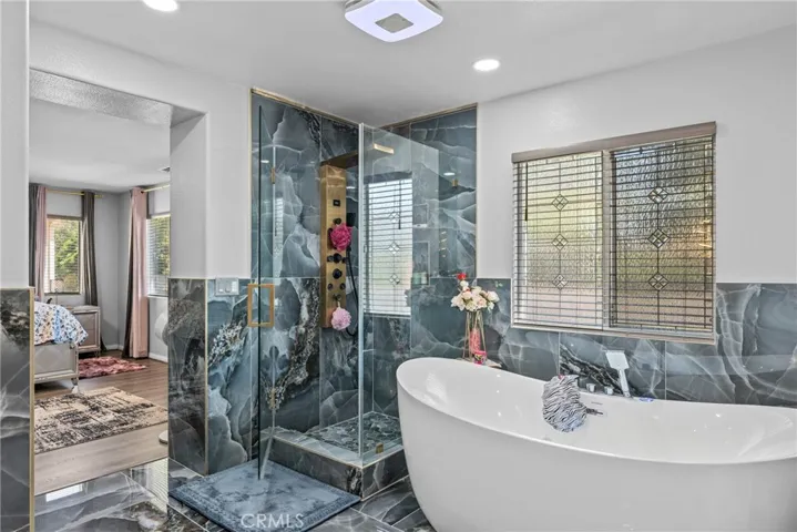 Elegant bathroom highlighting the stylish soaking tub and large window.