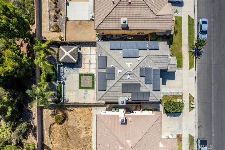 Top-down aerial view highlighting the property's roof and lot layout.