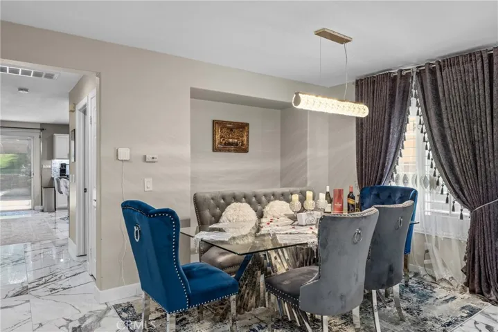 Formal dining room beautifully appointed with elegant drapery.