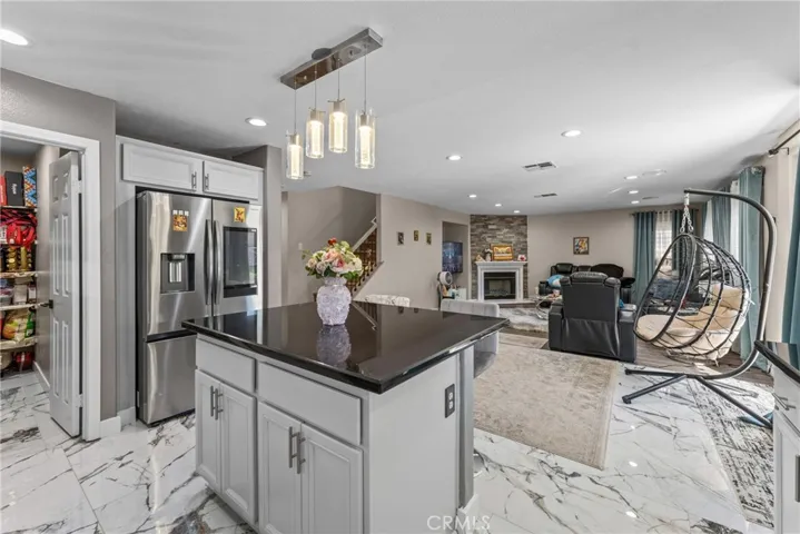 Bright and open kitchen featuring white cabinetry and a center island.