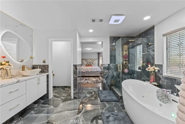 Luxurious primary bathroom with a modern freestanding bathtub.