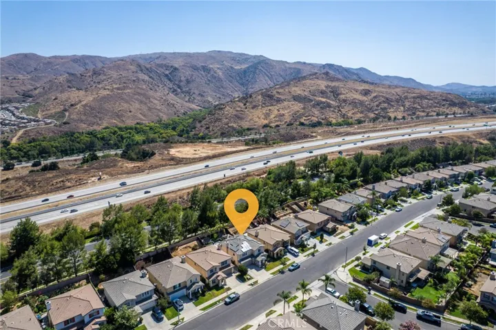 Expansive aerial view capturing the nearby highway and rolling hills.