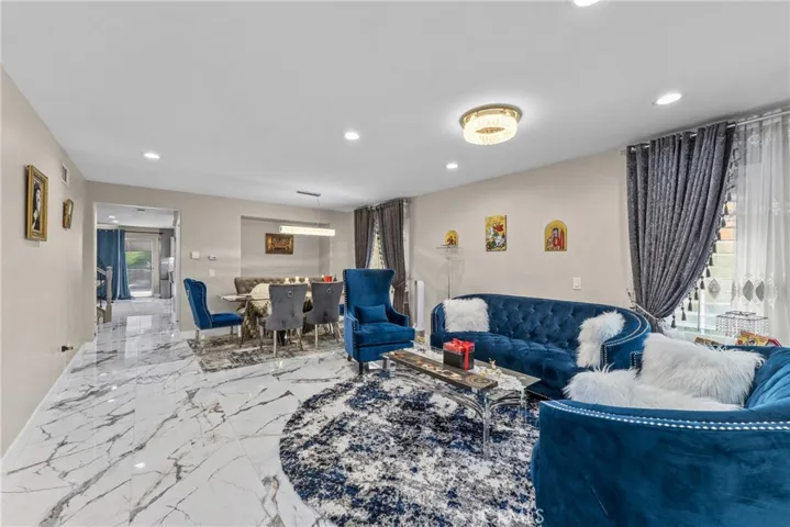 Spacious living area featuring a ceiling fan and sliding glass doors.