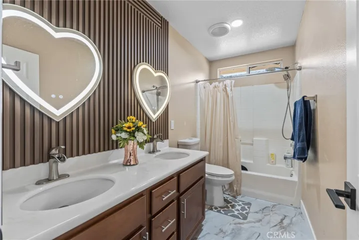 Stylish bathroom vanity with dual mirrors and contemporary fixtures.