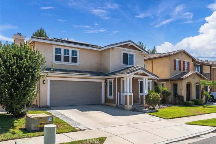 Stunning two-story home with a spacious driveway and attached garage.