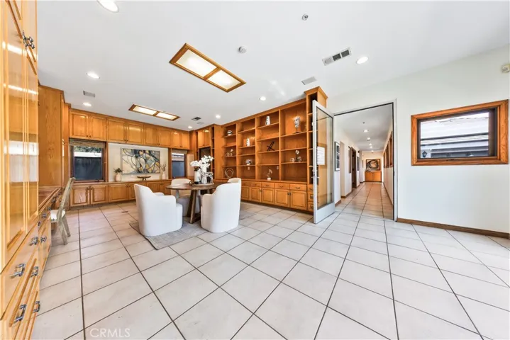 Huge recreation room with sliding glass doors providing direct access to the side yard.