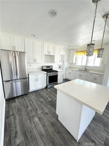 Open Kitchen with Island and Stainless Steel Appliances