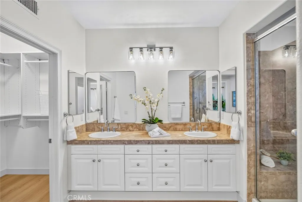 Primary bathroom, recently updated with new floorings, lighting, paint and mirrors
