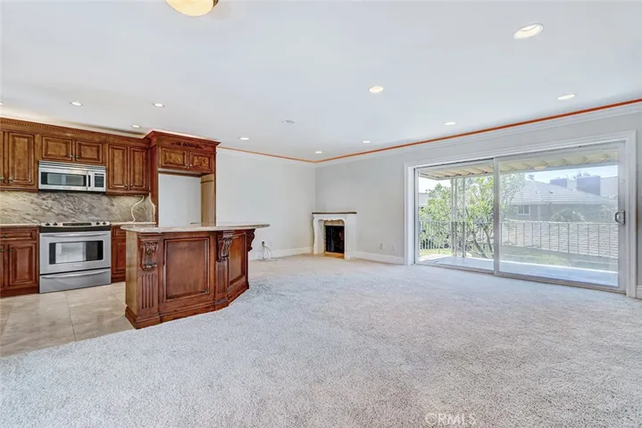 Living room and large slider leads to covered deck
