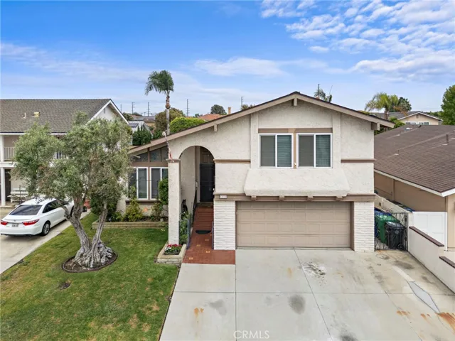 Front of house, palm trees and ocean breeze