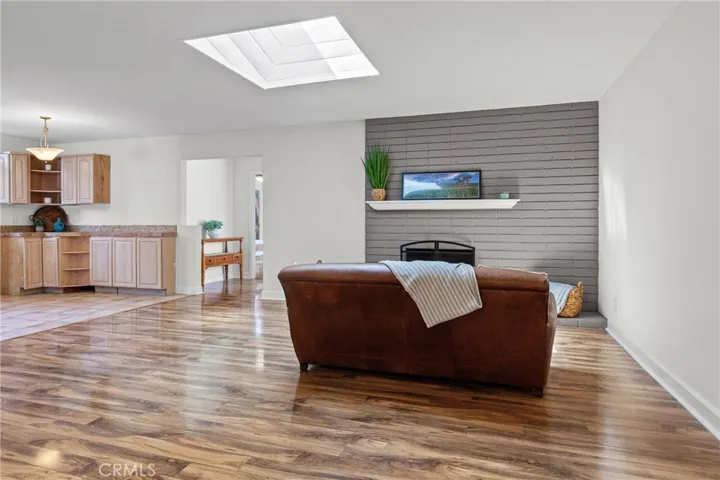 Freshly painted Living room with skylight, vaulted ceilings and fireplace