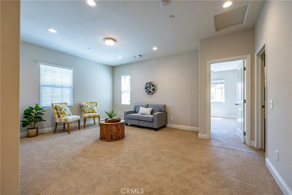 At the top of the stairs we find a family room with recessed lighting.