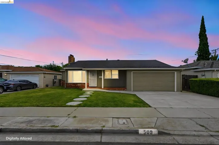 Single-story residence featuring a two-car garage with a concrete driveway