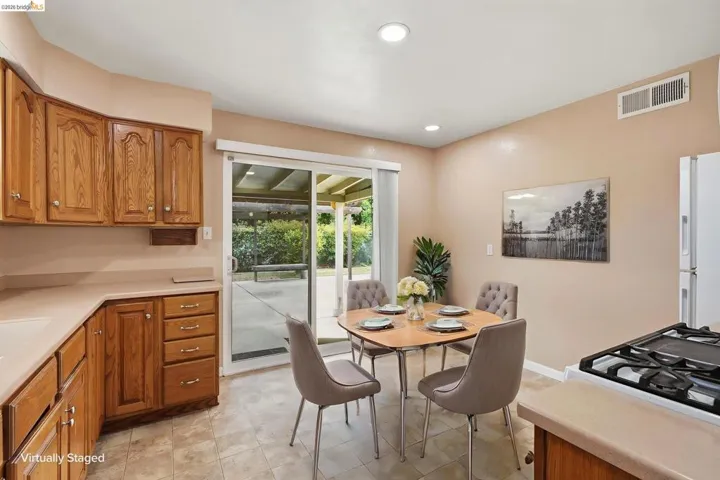 Kitchen featuring wood cabinetry, light countertops, and tile flooring