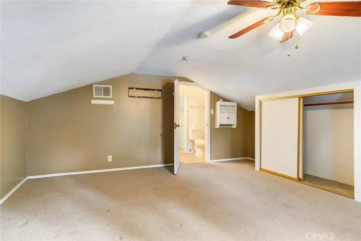 Attic Bedroom with Ceiling Fan and Closets