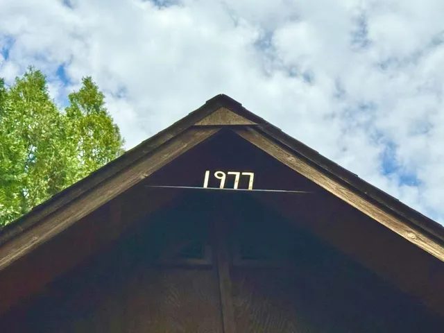 Construction year handcrafted in iron and gilded with gold leaf, located at peak of roof in rear