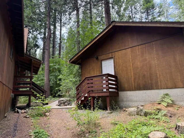 Exterior of garage as seen from behind. House's front steps are to the left.