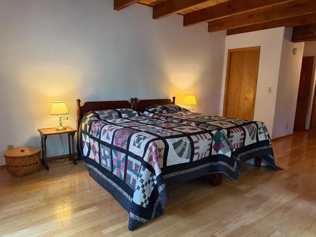 Primary bedroom on ground floor features soundproof wall between living room and headboard