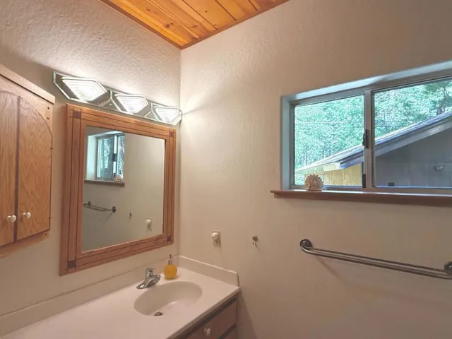 The hall bathroom features a shower stall and cleverly placed storage