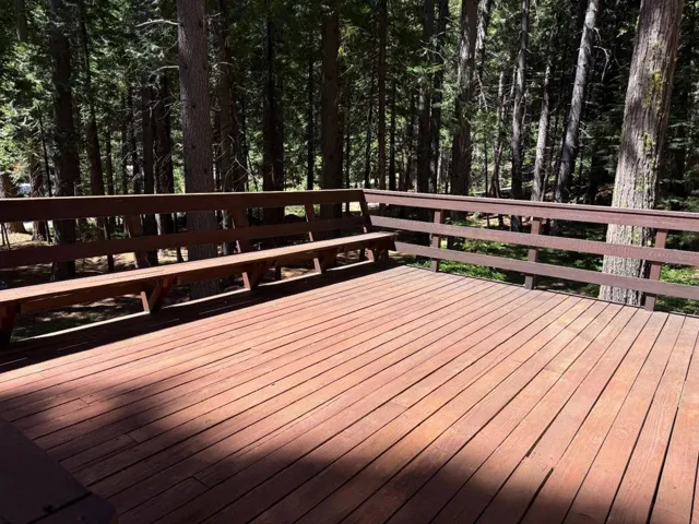 Deck with built-in bench, accessible by sliding door from dining area or by stairs from backyard
