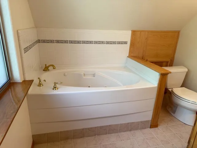 The upstairs bedroom has an oversized jetted tub with easy access to plumbing for maintenance