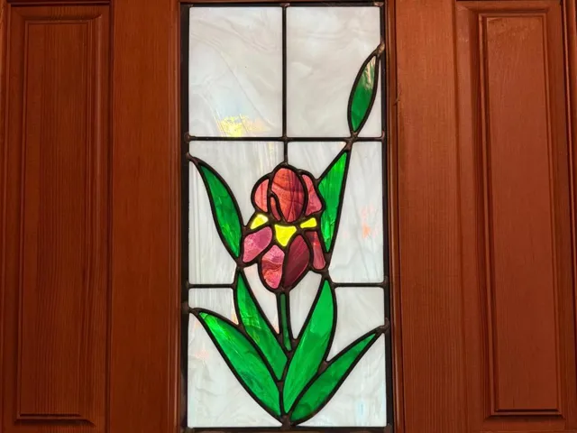 A stained glass purple iris is set into the front door