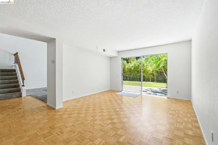 Hardwood parquet flooring with white walls and a white ceiling