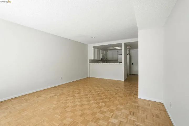 Bright living area featuring wood-finish parquet flooring and neutral wall tones