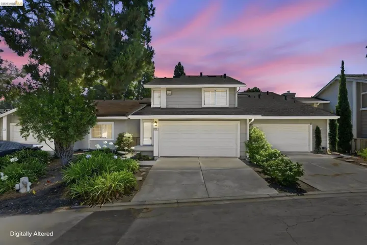 Two-story residential exterior featuring light gray siding and white trim