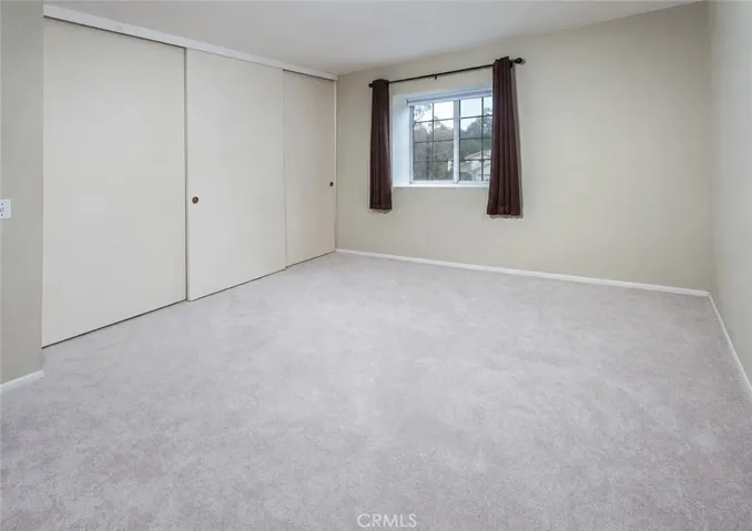 Secondary bedrooms offer generous closet space, including mirrored closet doors in one room.