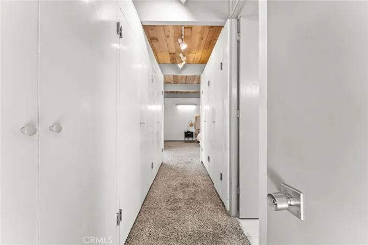 Hallway leads to the primary bedroom with plenty of closet space