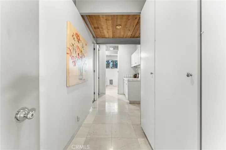 Hallway leading to the 2nd bathroom, 2 bedrooms and laundry area