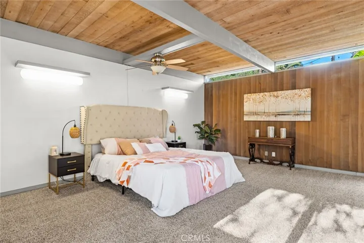 Spacious primary bedroom with 2 sliding glass doors.  One leads to a separate patio and the other to the private jacuzzi tub