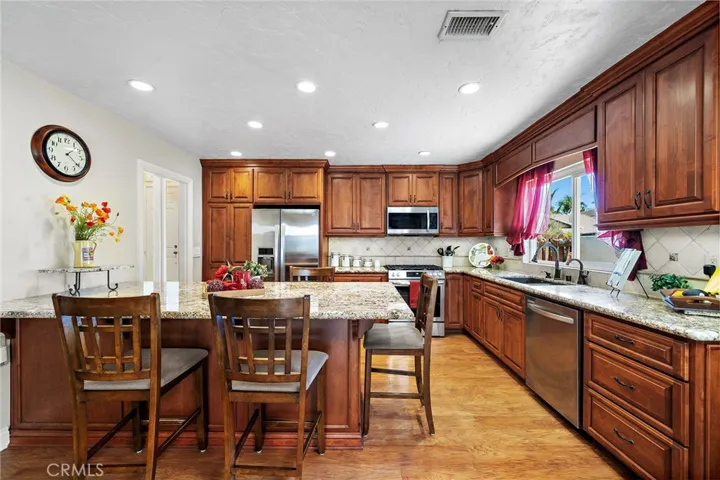 The remodeled kitchen features custom wood cabinetry with soft-close cabinets